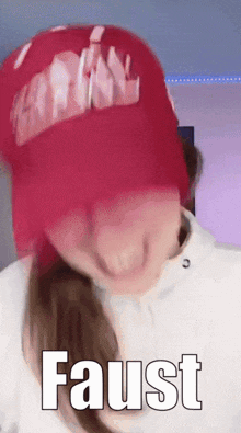a woman wearing a red hat says faust