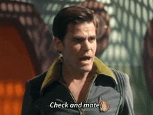 a man says check and mate while standing in front of a window