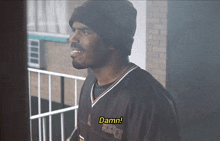 a man wearing a jersey that says damn