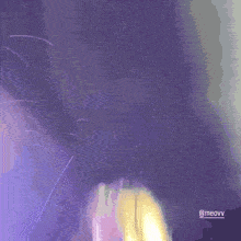 a blurry picture of a woman 's face with the name meavv on the bottom right corner