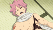 a woman with red hair is laying on the floor with a bandage around her chest