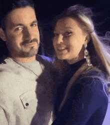a man and woman are posing for a picture together