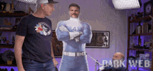 two men are standing next to a cardboard cutout of a man in a fantastic four costume ..