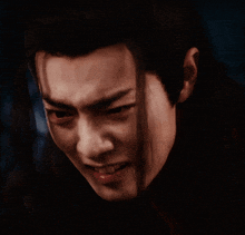 a close up of a man with long black hair