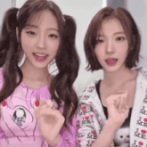 two girls are posing for a picture and one is wearing a jacket that says i love me