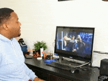 a man sits in front of a samsung computer monitor