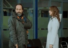 a man and a woman are standing next to each other
