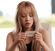 a woman is holding a card that says ' instructions manual ' on it