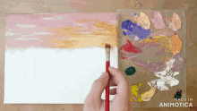 a person is painting a sunset on a canvas with the words made in animotica on the bottom