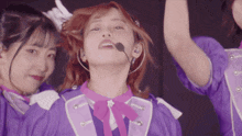 a girl in a purple outfit has a microphone around her ear