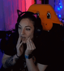 a woman wearing a cat ear headset is sitting in a chair