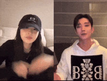 a man and a woman are making a heart with their hands