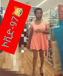 a man in a pink dress is walking down a store aisle with a red sign that says low
