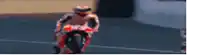 a motorcycle racer is riding a motorcycle on a race track .