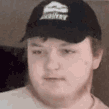 a close up of a man wearing a hat and making a funny face .