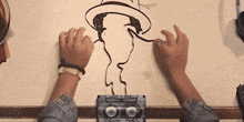 a person is drawing a picture of a man with a hat on a cassette tape that says pablo yes