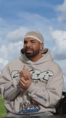 a man wearing a hoodie that says cbt is clapping his hands