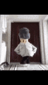 a cartoon character is standing in front of a door with chinese writing on it