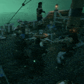 a group of people are standing around a table with a green light on it