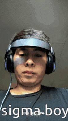 a man wearing headphones and a visor with the words sigma boy written on the bottom
