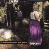 a woman in a purple skirt is standing next to another woman in a red skirt