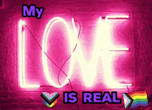 a neon sign that says my love is real on it