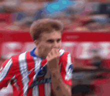 a blurry picture of a man wearing a red white and blue striped shirt