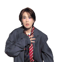 a woman in a suit and tie is making a funny face