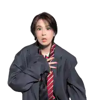 a woman in a suit and tie is making a funny face