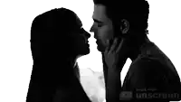 a man and a woman are kissing in a black and white photo made with unscreen