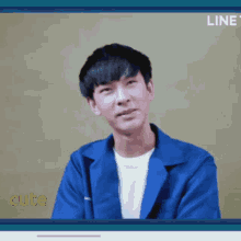 a man in a blue jacket is on a screen that says line cute