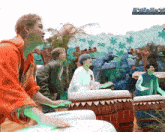 a group of young men are playing drums in front of a sign that says ' jungle '