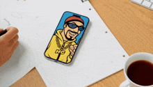 a phone with a cartoon of a man with the letter g on his shirt
