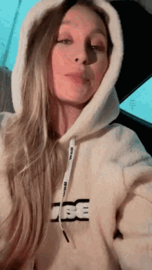 a woman wearing a hoodie with the letter e on the front
