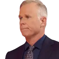 a man in a suit and tie is looking to his left