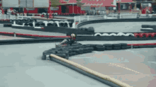 a person is riding a go kart on a track that says rtve in the background