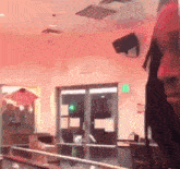 a man is standing in a restaurant with a microphone .