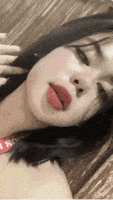 a close up of a woman 's face with red lipstick on .