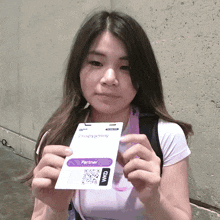 a woman is holding a crispypenny badge
