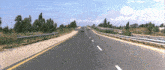 a car is driving down a highway with a yellow line on the side