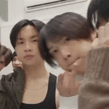 a group of young men standing next to each other in a room .