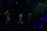 a group of people are dancing on a stage with a clock behind them that says 3:39