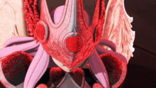 a close up of a cartoon character with a red crown on her head