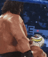 a man in a mask is being punched by another man