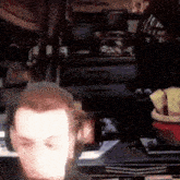 a man is sitting in front of a computer screen .