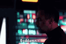 a man in a black turtleneck says goddammit