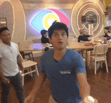 a man in a blue shirt with dustin on the front