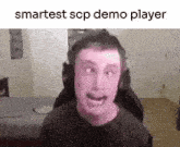 a man wearing headphones is making a funny face while sitting in a chair in a room .