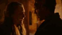 a man and a woman are looking at each other .