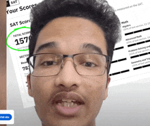 a man wearing glasses has a total score of 157